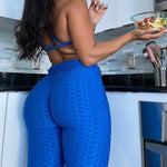 Load image into Gallery viewer, Girl wearing blue booty scrunch leggings kitchen
